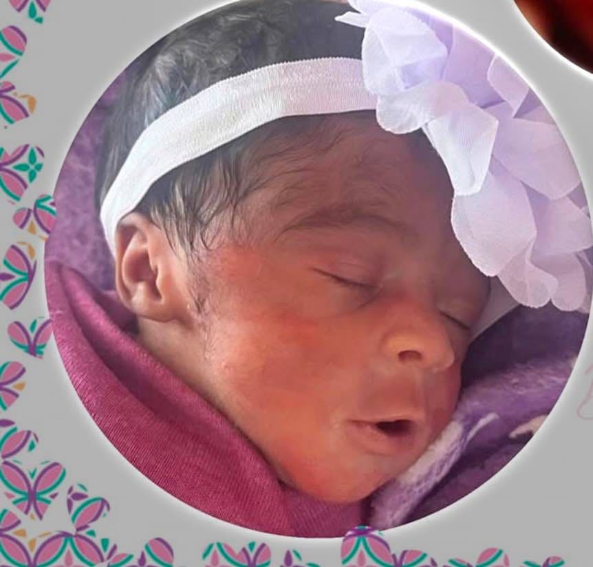 Harper smiling in her blanket